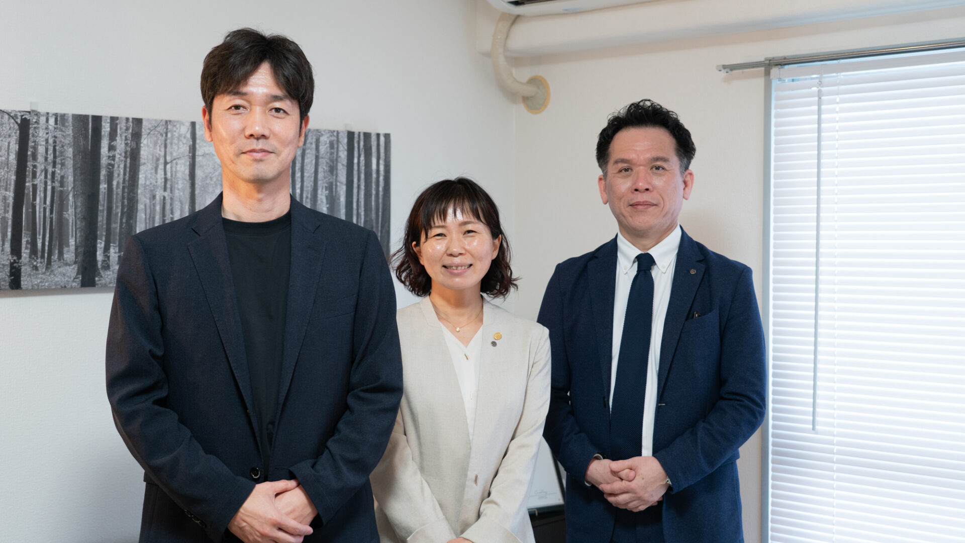 インタビュー後に撮影された3名の集合写真、笑顔で並ぶ3名